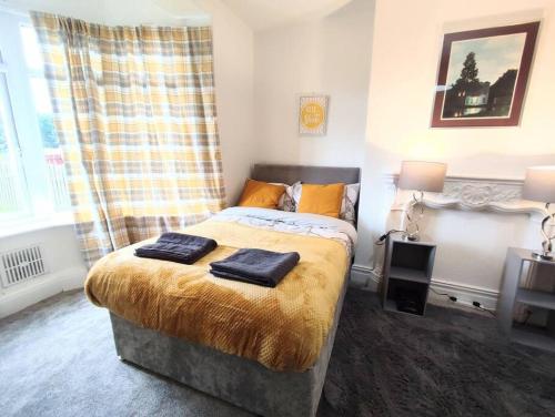 a bedroom with a bed with two towels on it at Northern Breeze Apartment in Cambois