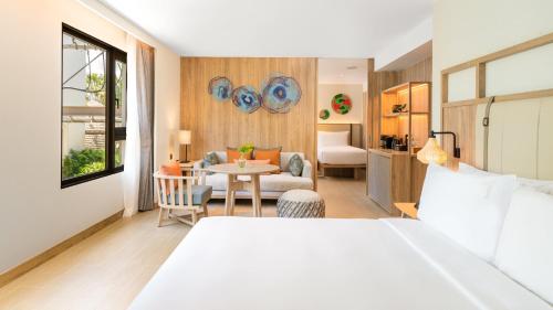 a hotel room with a bed and a dining room at Holiday Inn Resort Samui Bophut Beach by IHG in Bophut 