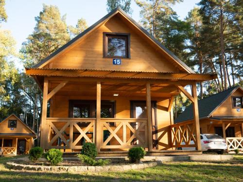 a log cabin with a gambrel roof at Ośrodek Wypoczynkowy Laguna in Lubniewice