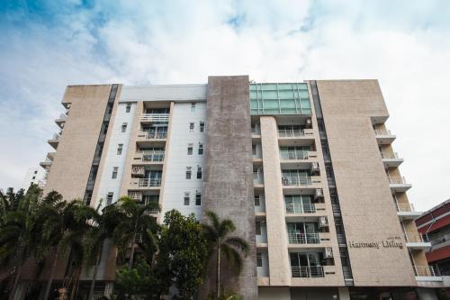 a tall building with palm trees in front of it at 2C-Short-term rental allowed-2BRs Downtown Bangkok in Bangkok