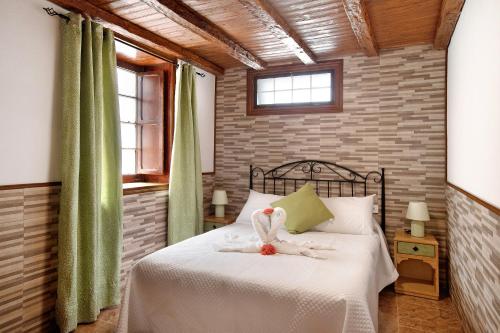 a bedroom with a bed with a stuffed bird on it at los diablitos 2b in San Juan de la Rambla