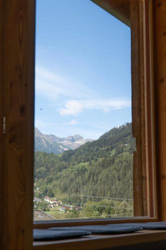 a window view of a valley from a mountain at Chalet Schmelz Huette mit Sauna und Garten in Flattach
