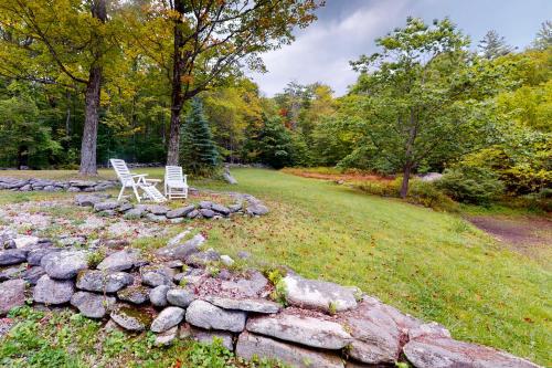 two white chairs sitting on a rock wall at Hoot Owl Hollow in Jacksonville