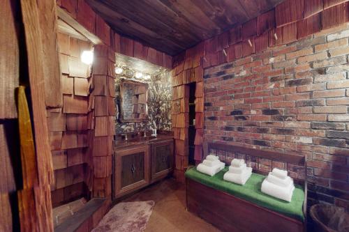 a bathroom with a sink and a brick wall at Hoot Owl Hollow in Jacksonville