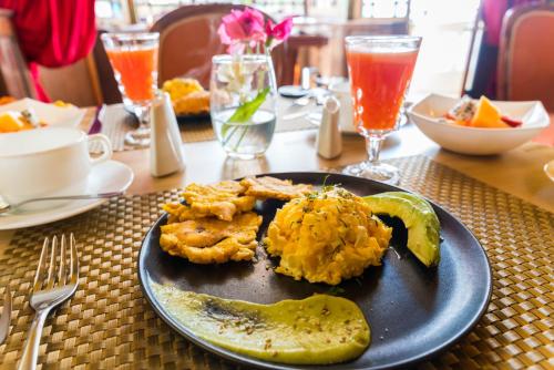 a plate of food with shrimp and a pickle on a table at Boutique Hotel in Quito Hotel Casona 1914 in Quito