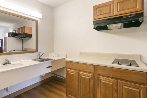 a bathroom with a sink and a mirror at Red Roof Inn Forsyth in Forsyth