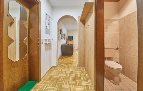 a corridor of a bathroom with a toilet and a sink at Appartement Mountain & Fun in Saalbach Hinterglemm