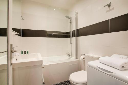 a bathroom with a toilet and a sink and a shower at La Villa Normande - Studio - Deauville Centre in Deauville