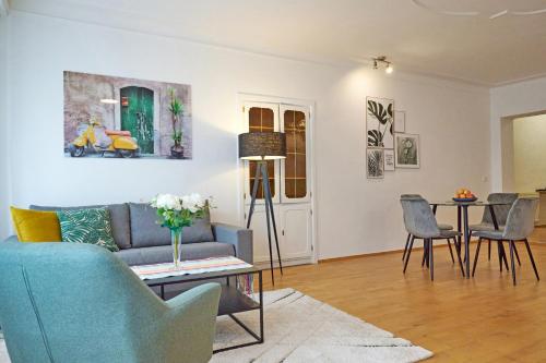 a living room with a couch and a table at Apartment im Zentrum von Ried im Innkreis in Ried im Innkreis