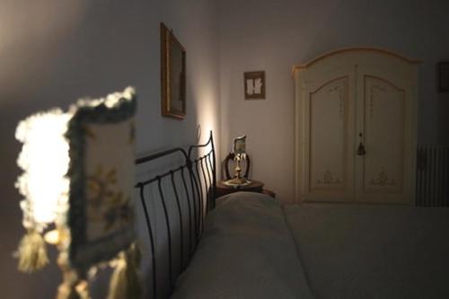 a bedroom with a bed and a white door at Le Scalelle B&B in Scorpeto