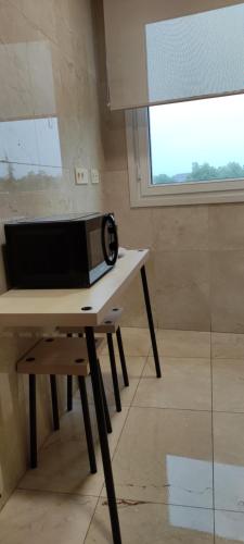 a microwave sitting on a table in a room with a window at Divina 10 in Avilés