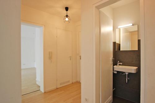 a bathroom with a sink and a mirror at LaMiaCasa Design Apartment near Ludwigsburg 2,5 rooms 75 sqm in Schwieberdingen