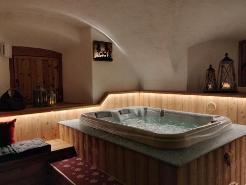 a jacuzzi tub sitting in a room with at La Fattoria di Roven in Gignod