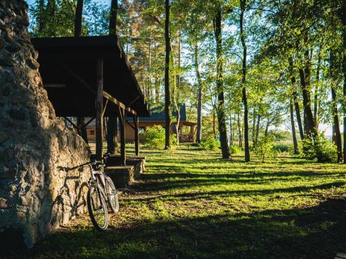 a bike parked next to a stone wall in a park at Ośrodek Wypoczynkowy Laguna in Lubniewice