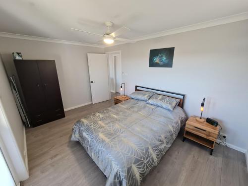 a bedroom with a bed and a ceiling fan at Magic in Medlow in Medlow Bath
