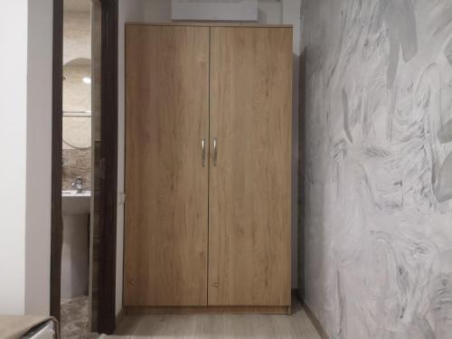 a wooden cabinet in a bathroom with a sink at 7ROOMS boutique hotel in Yeghegnadzor