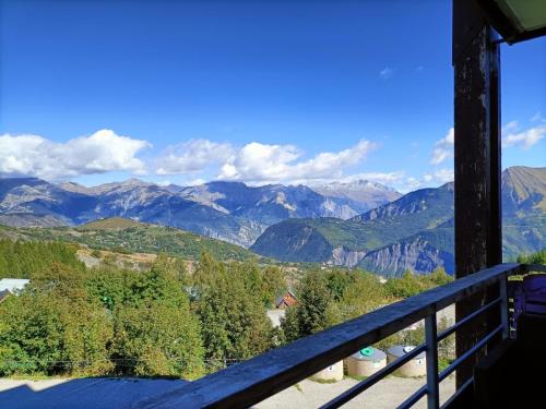a view of mountains from the balcony of a house at Appartement 2 Chbres Calme Vue vallée 500m des pistes in Le Corbier