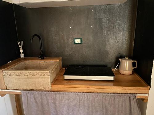 a kitchen counter with a stove and a sink at Agriturismo Mulino in Pietra in Casina