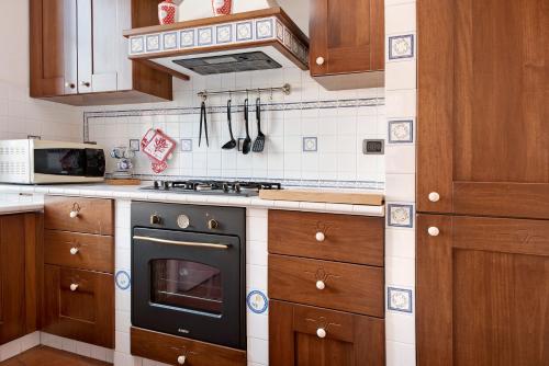 a kitchen with a stove top oven in a kitchen at A due passi dal mare in Chiavari