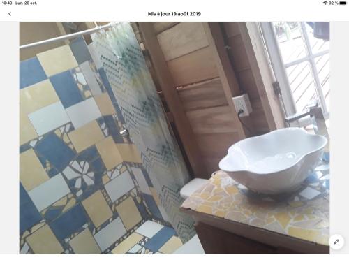 a bathroom with a sink on a counter with a mosaic wall at Life is Good in Bocas del Toro