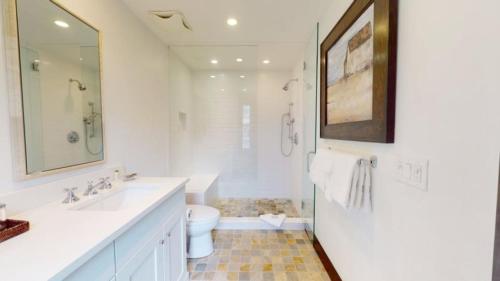 a white bathroom with a sink and a toilet at Ski In, Ski Out, 3 Bedroom Luxury Residence On Fanny Hill In Snowmass Village in Snowmass Village