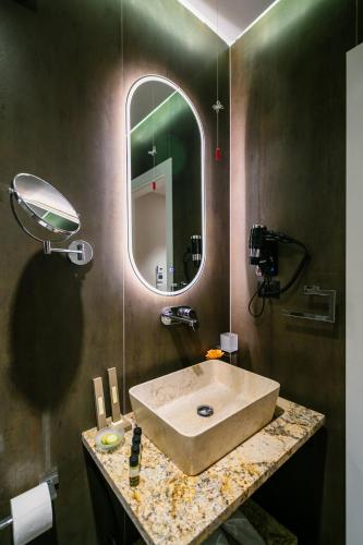 a bathroom with a sink and a mirror at Vecchia Boutique Hotel in Korçë