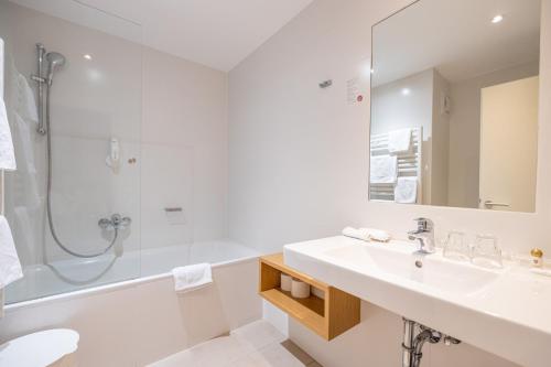 a bathroom with a sink and a shower at Landhotel Atzmüller in Waxenberg