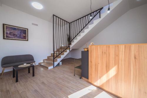 a living room with a staircase and a chair at Zoe Pirot in Pirot