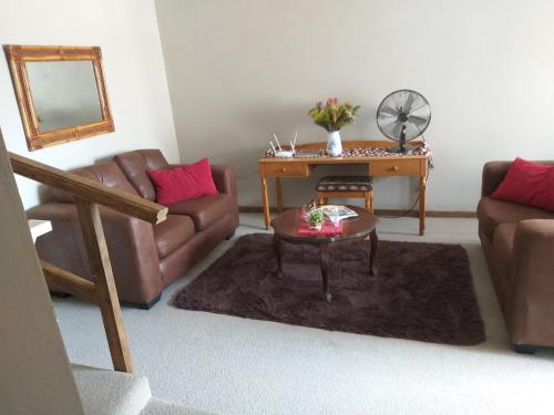 a living room with a couch and a table at Prince Alfreds in Caledon