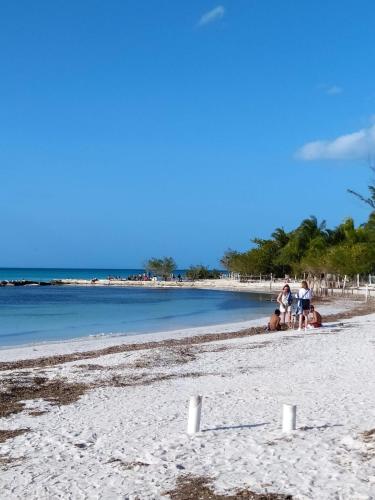 a group of people sitting on a beach at Casa aloha-Isla Holbox in Holbox Island