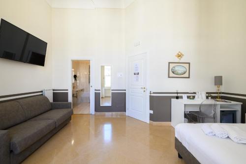 a living room with a couch and a television at Residenza Molinari Suite in Naples