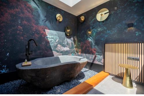 un bagno con una grande vasca in una stanza di Lo hotel del poblet a El Poblenou del Delta