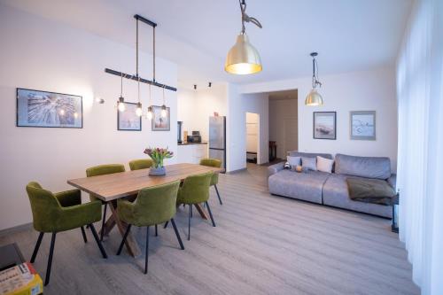 a living room with a table and a couch at Revalia Vintse Villas in Vintse