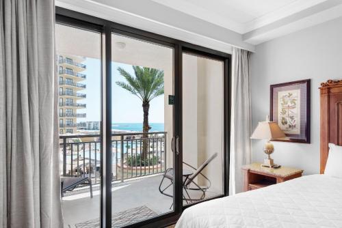 a bedroom with a bed and a view of the ocean at Emerald Grande W222- Rexford's BEACH Retreat in Destin
