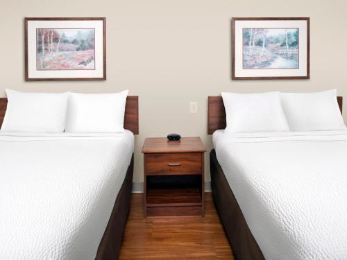 two beds sitting next to each other in a room at Extended Stay America Select Suites - Phoenix - West in Phoenix