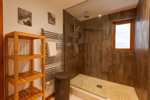 a bathroom with a shower and a toilet and a sink at White Lodge Apartments in Mawgan Porth