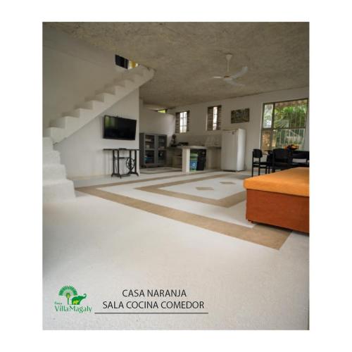 a large living room with a staircase in a house at FINCA VILLA MAGALY en medio de la Naturaleza in Melgar