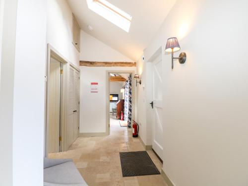 a hallway with white walls and a ceiling at Barley Cottage in Cheriton