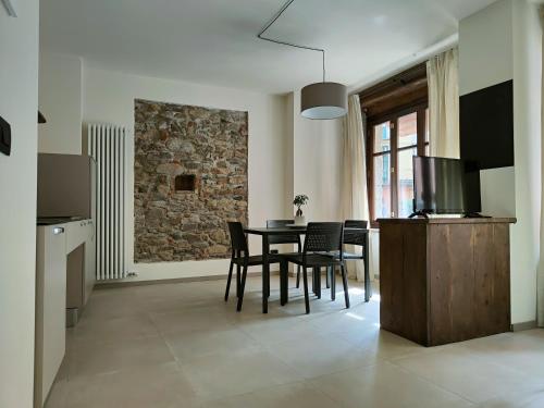 a kitchen and dining room with a table and chairs at Domus Acaja in Pinerolo