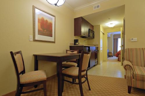 a kitchen and living room with a table and chairs at Country Inn & Suites by Radisson, Columbia at Harbison, SC in Columbia