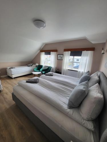 a large bedroom with a large bed and a couch at Grindavik Guesthouse self check in & out in Grindavík