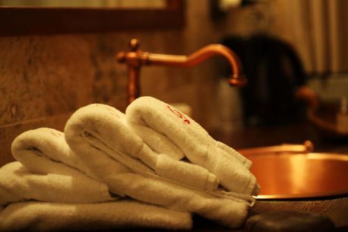 a pile of towels sitting on a counter next to a sink at Eco Chalet Maison Dominique in Challand Saint Anselme