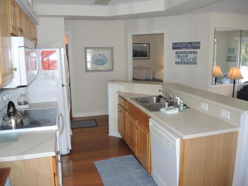 eine Küche mit einer Spüle und einem weißen Kühlschrank in der Unterkunft 2909M condo in Calabash