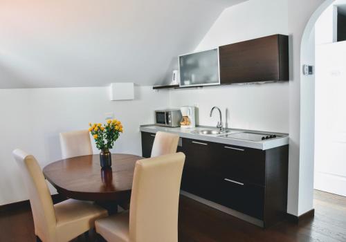 a small kitchen with a table and a sink at Celenga Apartments with free offsite parking in Dubrovnik