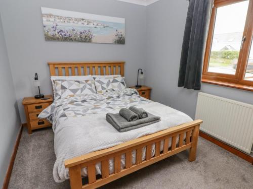 a bedroom with a bed with two towels on it at Ucheldir in Llanfyrnach