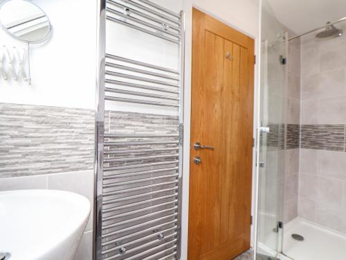 a bathroom with a shower and a toilet and a sink at Atlantic Reach in Marazion