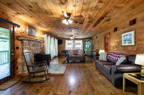 a living room with a couch and a fireplace at Forest Home Hot Tub Fire Pit Pool Table in Pigeon Forge