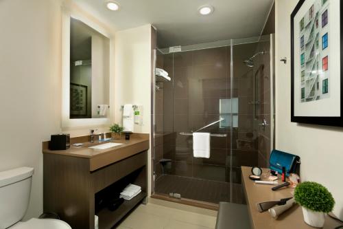 a bathroom with a shower and a sink and a toilet at Hyatt House San Juan in San Juan