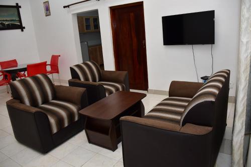 a waiting room with chairs and a flat screen tv at Sholay Villa in Galle