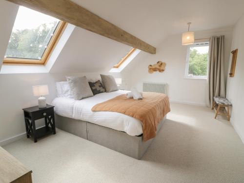 a bedroom with a large bed in a attic at The Coach House in Amlwch